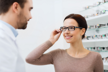 woman choosing eye glasses at the eye doctor